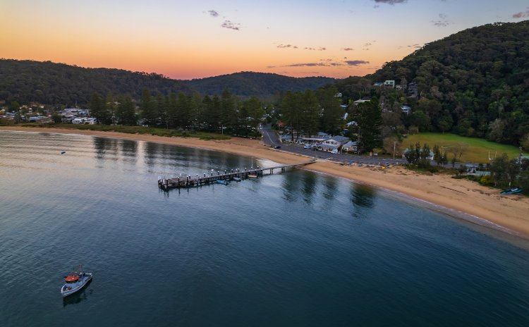 Fishing Boats and sunrise in Brisk Bay from Patonga Beach on the Central Coast of NSW, Australia.