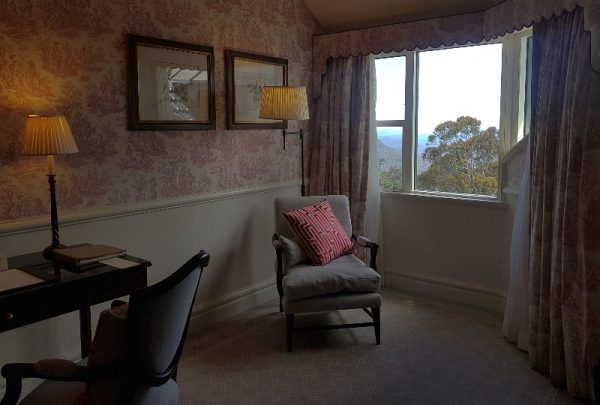 Deluxe view room Lilianfels with reading chair and window overlooking the valley