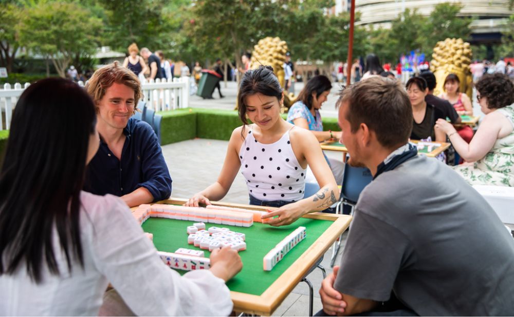 4 adults playing Mahjong