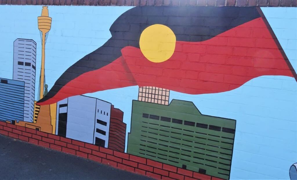 Indigenous Street art in Sydney featuring an Aboriginal Flag
