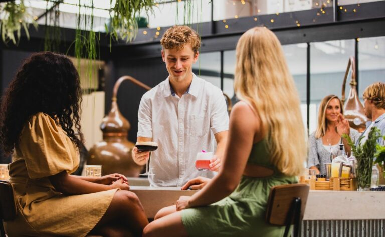Friends enjoying cocktails made with the Seadrift distilled non-alcoholic spirit at Seadrift Distillery, Brookvale.