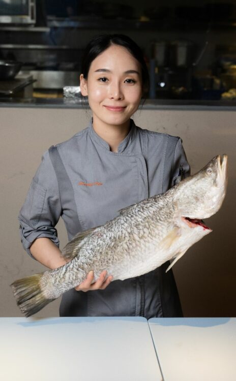 Chef with a whole fish at Sailmaker Kitchen Table