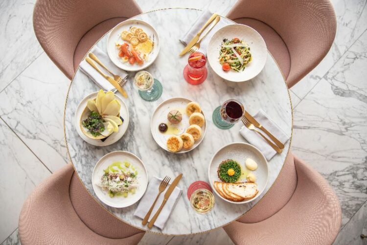 round table with pink chairs set for 4 people 