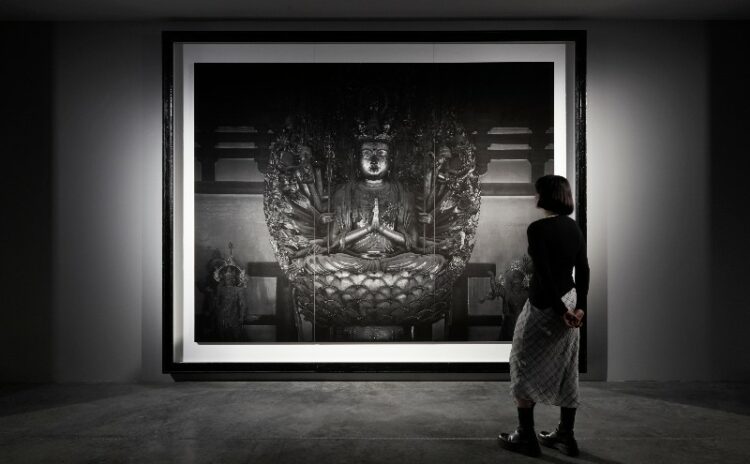 Hiroshi Sujimoto artwork of a Buddha with a woman looking at it 