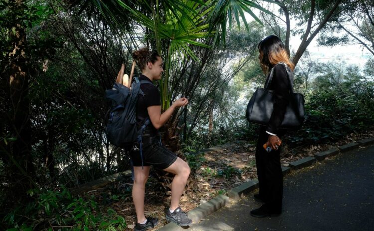 Tour guide at Barangaroo explaining plant use. 