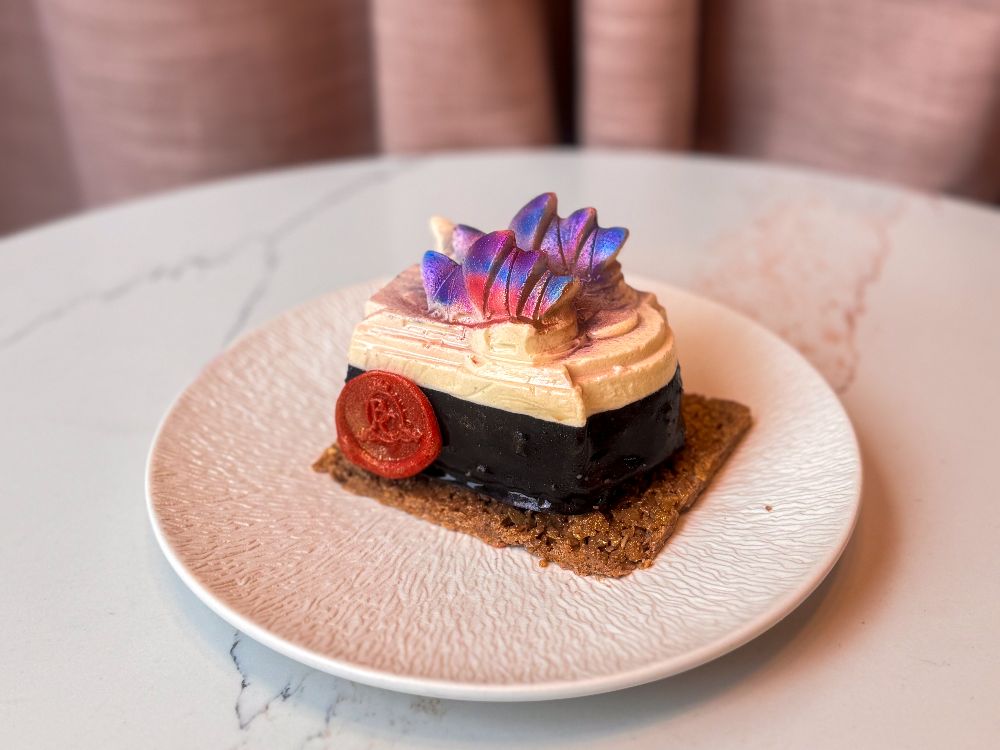 Bottega Coco's Vivid-themed Opera House Cake featuring coconut sponge, berry coulis and dark chocolate mousse