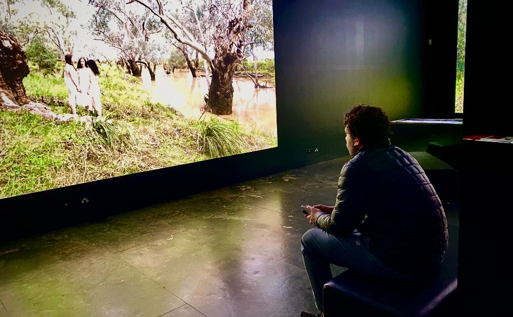 Man watching a video at the Blue Mountains heritage centre at Blackheath