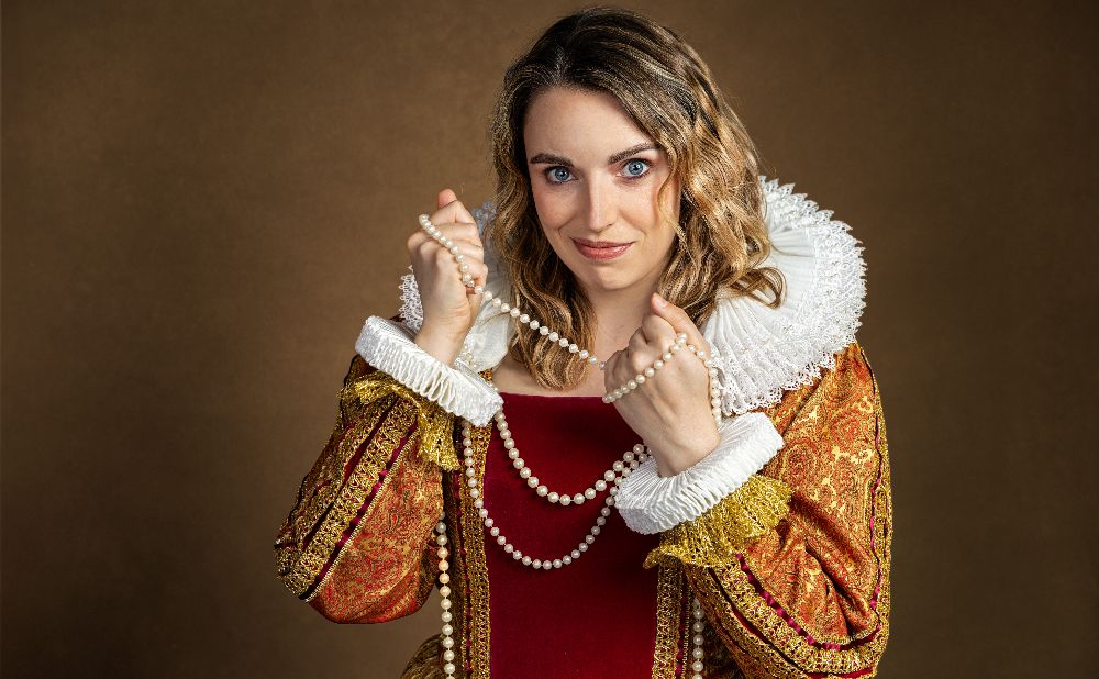 Elizabethan heroine clutching a string of pearls
