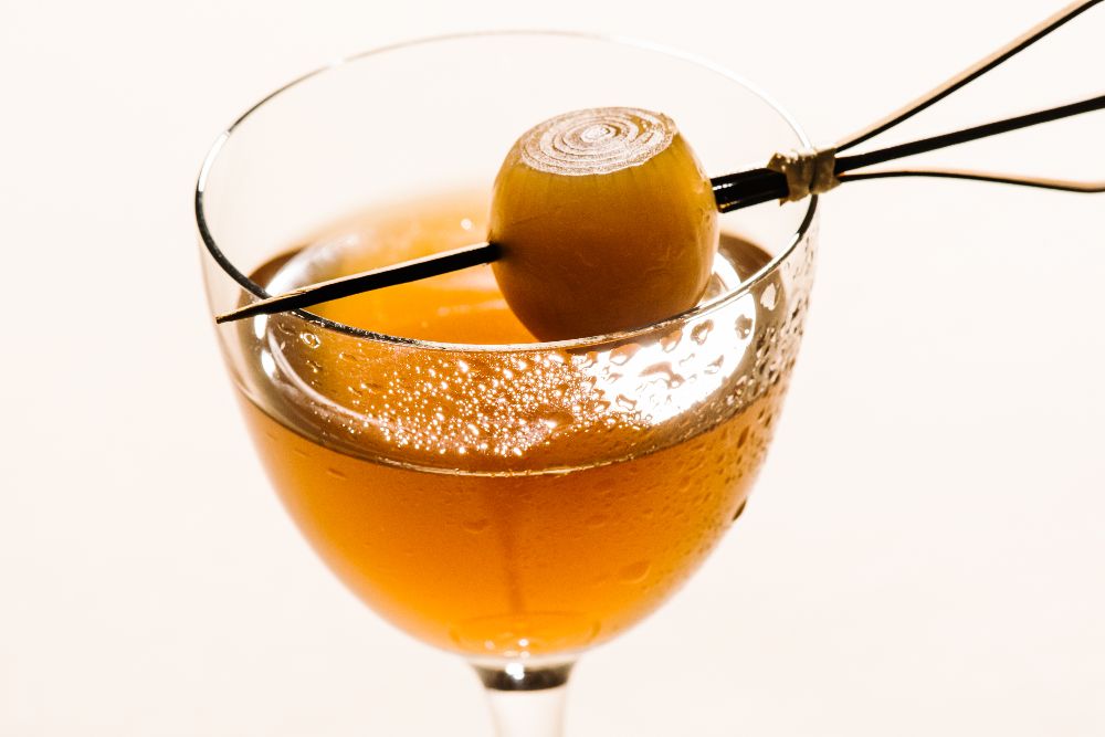 a martini with a pickled onion