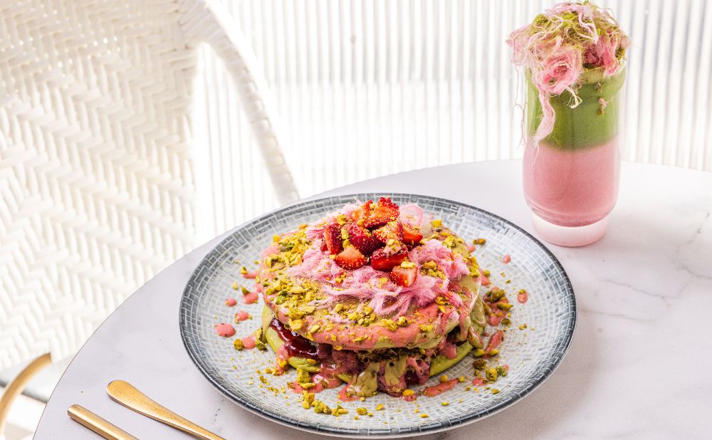 Strawberry Matcha Pancakes on white table with a pink strawberry matcha drink