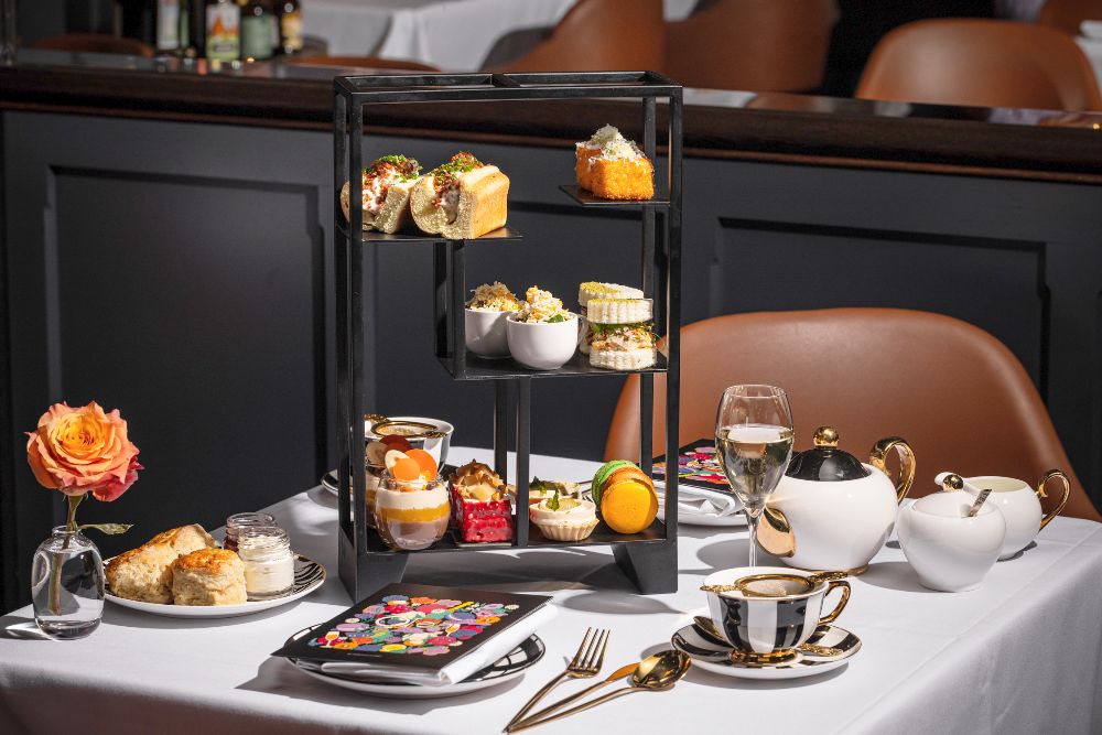 High tea setting with sweet and savory treats at QT hotel