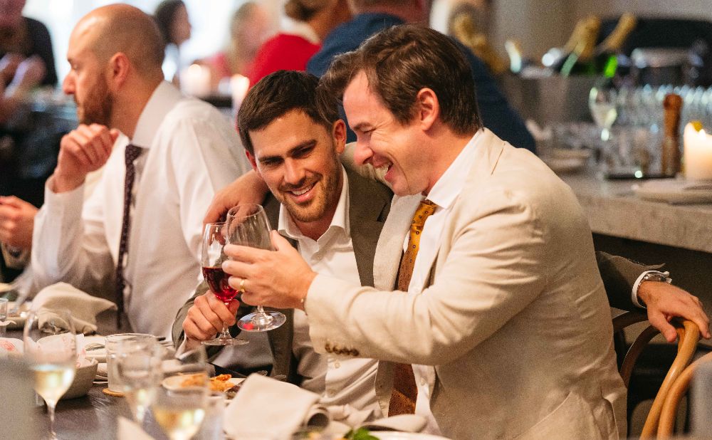 2 men comparing notes at the Apollo in Sydney on cup day