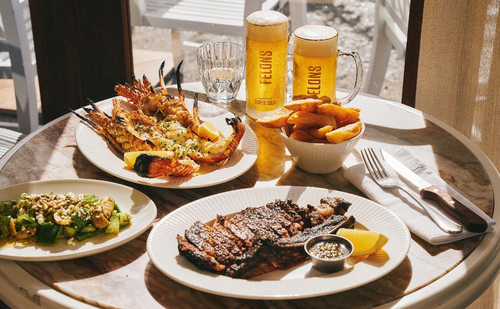 table with felons beer, and seafood meals