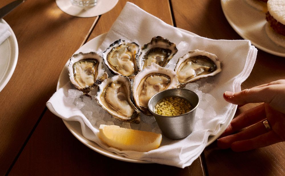 plate of fresh oysters with lemon and dipping sauce at Felons Manly