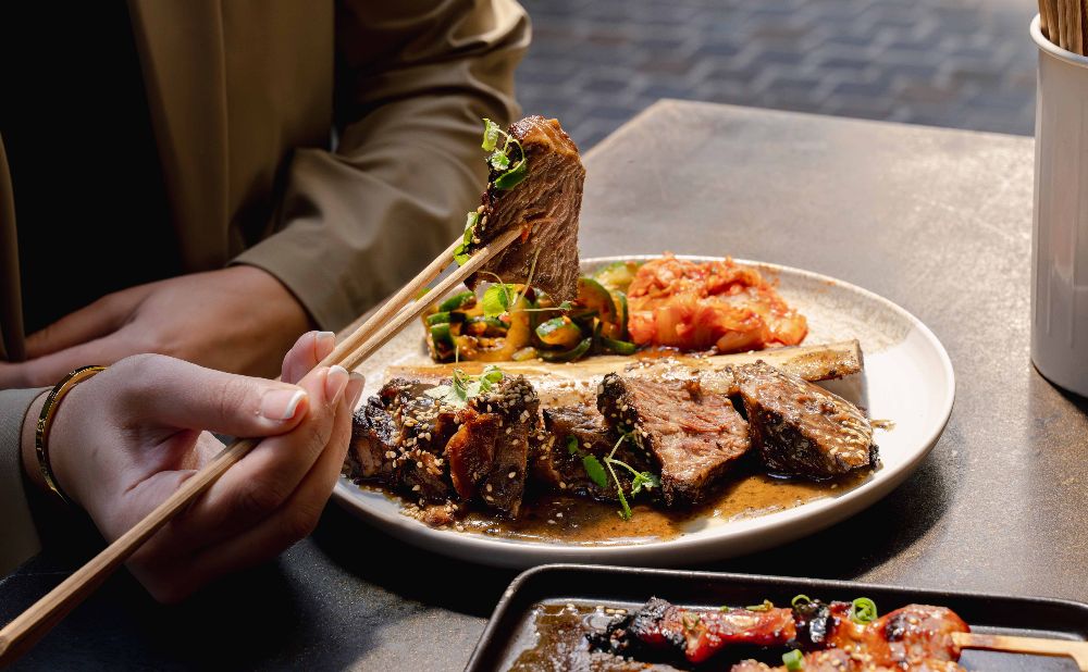 Plate of beef ribs with chopsticks.