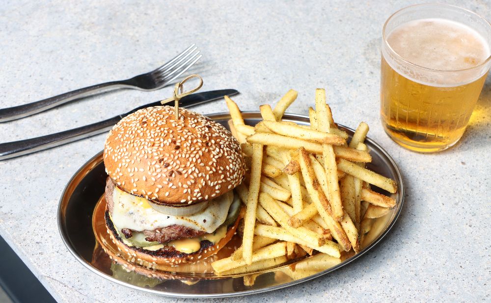 Cheeseburger with fries and a beer