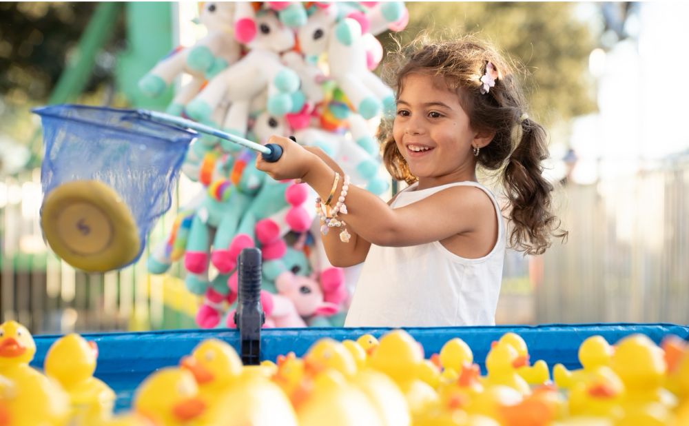Girl playing a carnival game at Rouse Hill 