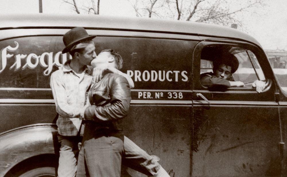 An image of two men embracing with a kiss from LOVING: A Photographic Collection of Love, 1850s–1950s