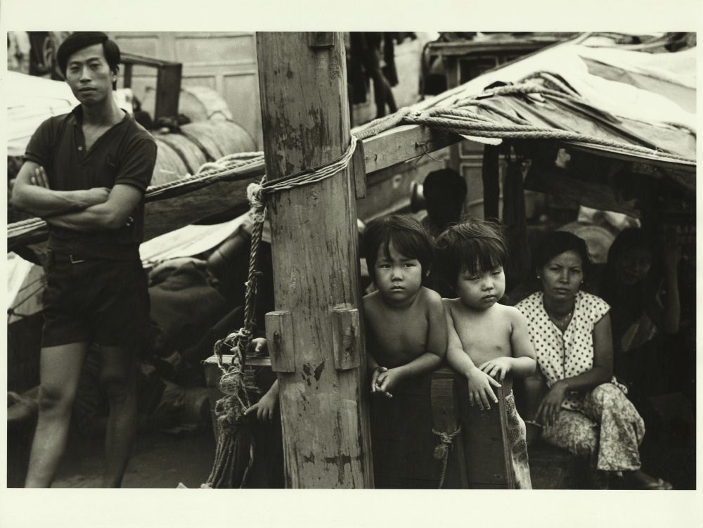black and white photograph of a Vietnamese family on a boat
