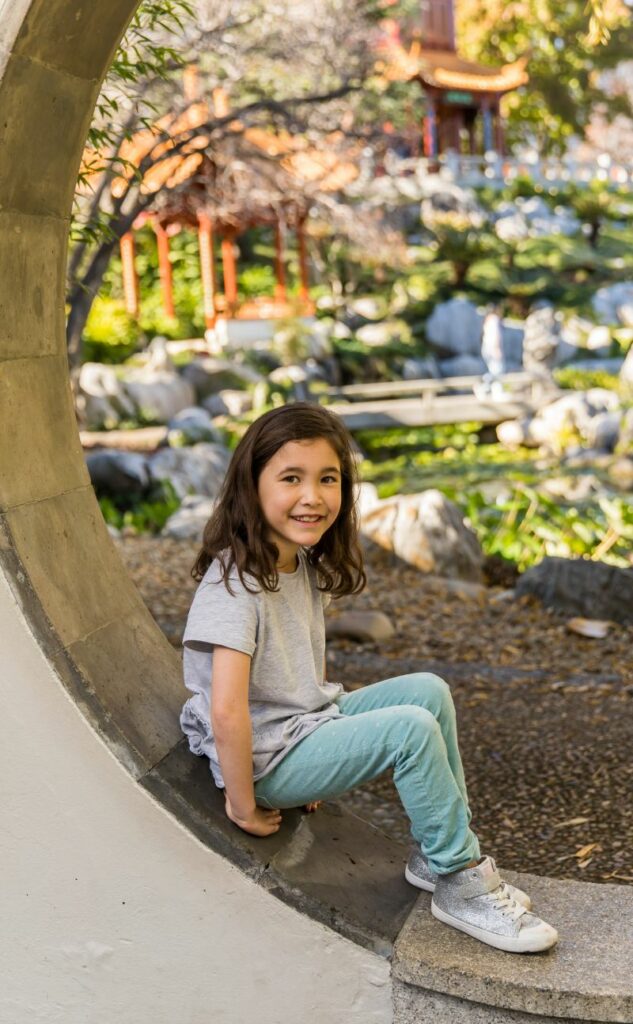 Child sitting in a window at the Chinese Garden of Friendship
