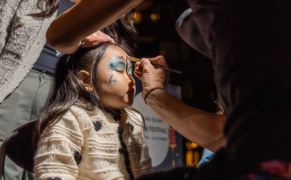 girl getting her face painted at Darling Square