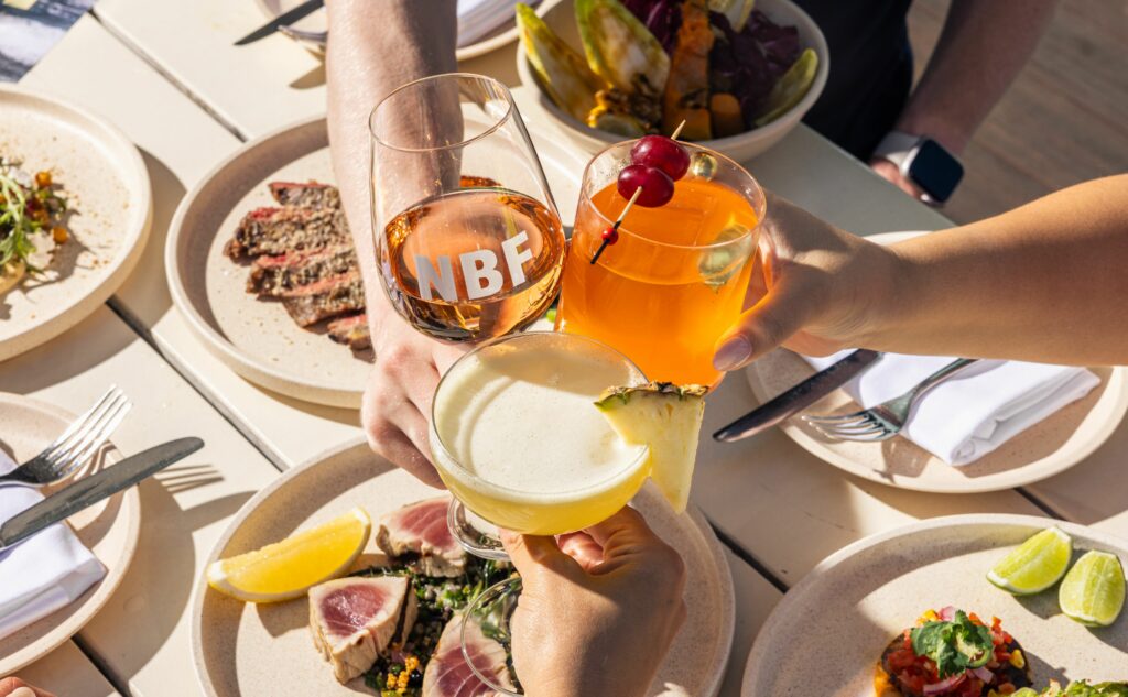 North Bondi FIsh glass of rose with cocktails above a lunch spread of tuna 