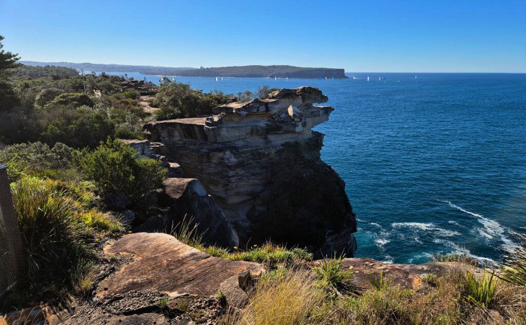 The cliffs of The Gap South Head looking to the Pacific Ocean with North Head in the distance
