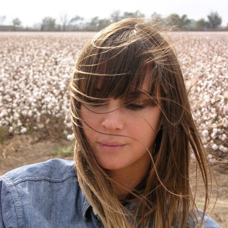 Muscian Cat Power in a field of flowers